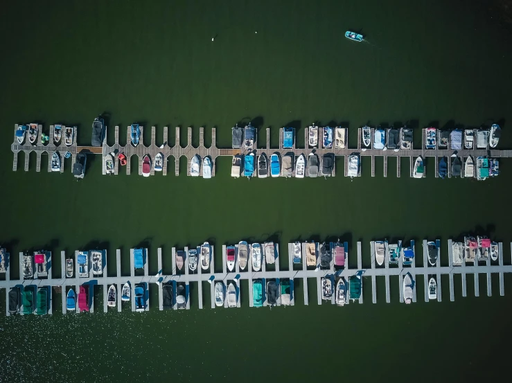 a number of boats in a body of water, boat dock, top down photo at 45 degrees, thumbnail, shot on sony a 7