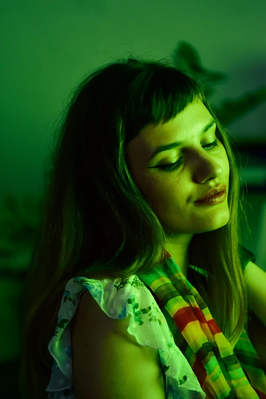 a close up of a person holding a cell phone, an album cover, inspired by Elsa Bleda, green accent lighting, side portrait of imogen poots, brightly colored, mid - shot