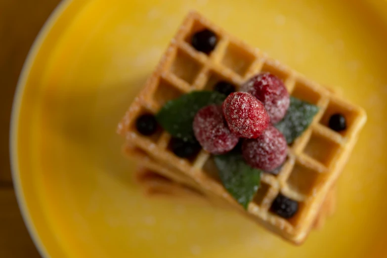 a waffle topped with raspberries on a yellow plate, a portrait, by Emma Andijewska, pexels, renaissance, square, winter, bells, 15081959 21121991 01012000 4k