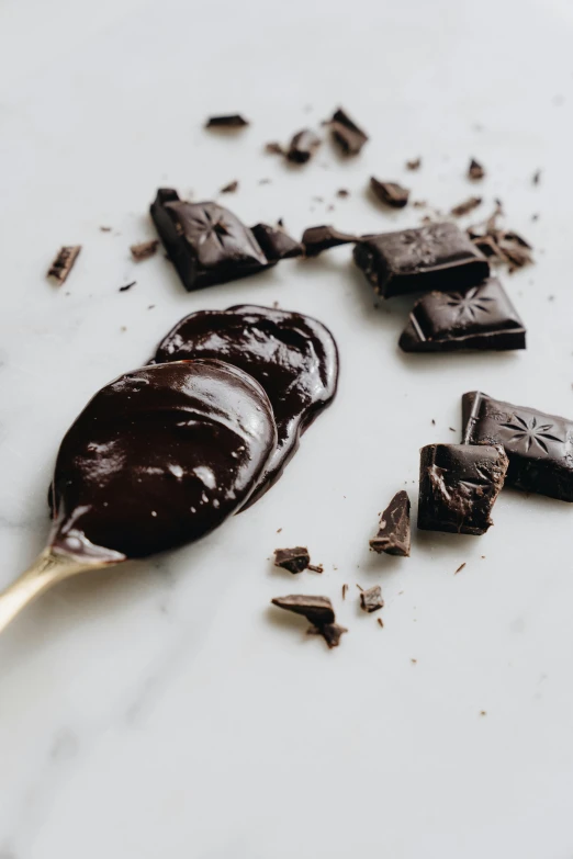 a close up of a spoon with chocolate on it, by Jessie Algie, all black matte product, bark for skin, seaside, fuji choco