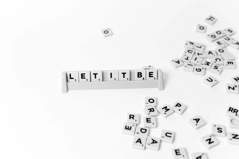 a bunch of letters sitting on top of a table, by Daniel Lieske, pixabay, letterism, let there be light, on a white background, underbite, tetris