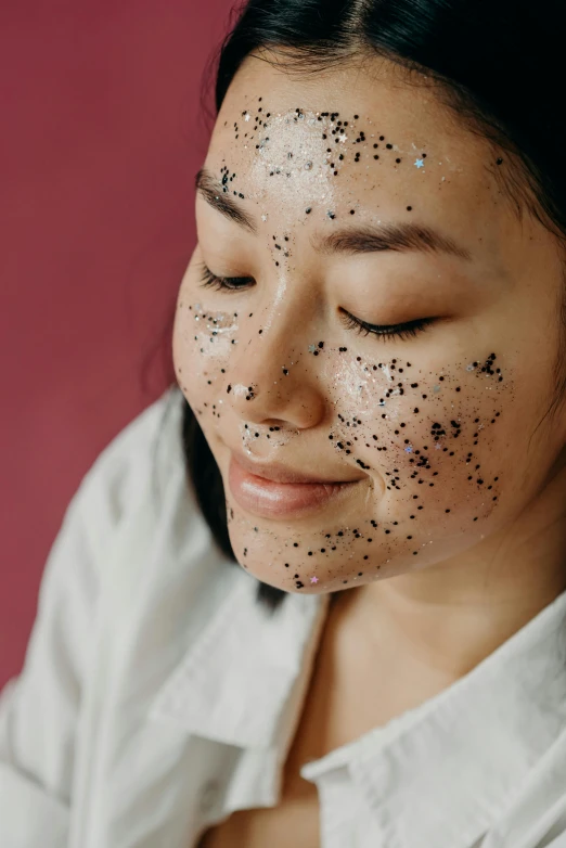 a woman with black spots on her face, trending on pexels, mingei, textured base ; product photos, starry, korean, detailed face and body