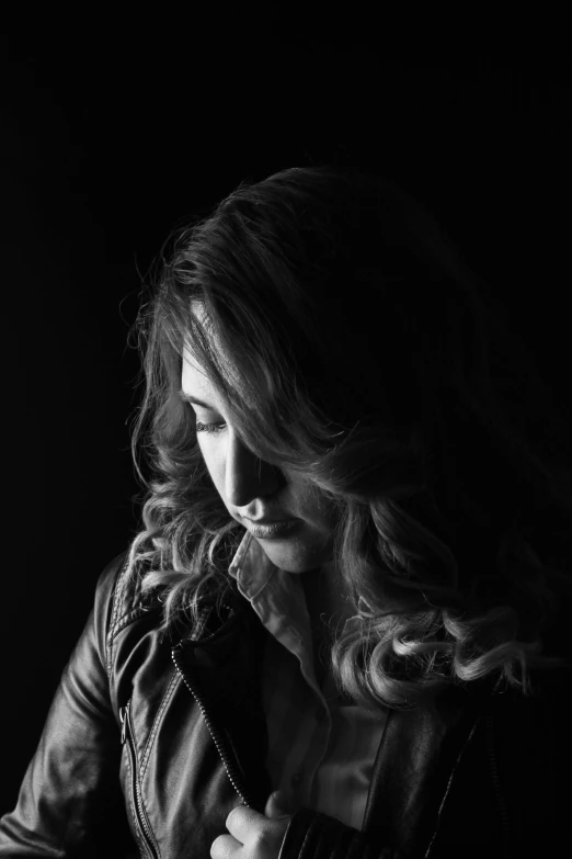 a black and white photo of a woman in a leather jacket, inspired by Yousuf Karsh, trending on pexels, flowing backlit hair, backlight photo sample, studio!! portrait lighting, portrait color glamour