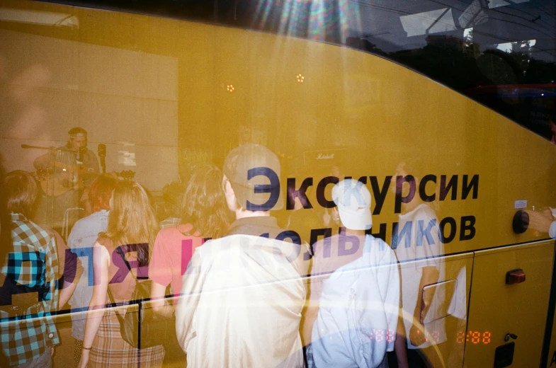 a group of people standing in front of a bus, a poster, inspired by Vladimir Borovikovsky, unsplash, yellow scheme, 000 — википедия, epicurious, photographed from behind