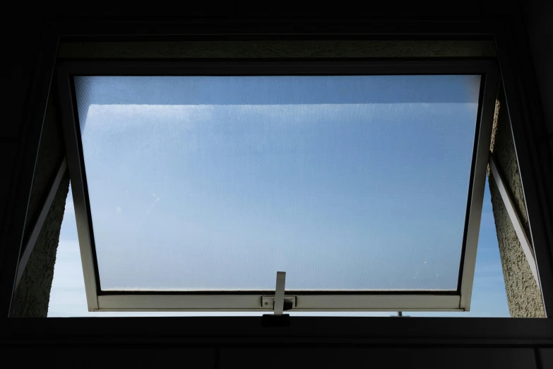 a bathroom window with a skylight above it, a portrait, unsplash, dark blue sky, thin fog, taken in the late 2010s, the clear sky