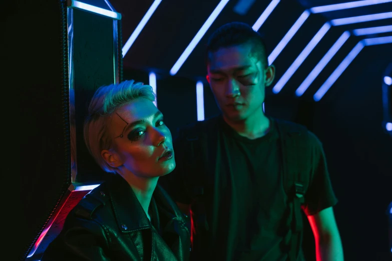 a man and a woman standing next to each other, cyberpunk art, pexels contest winner, bauhaus, edgar maxence and ross tran, in a nightclub, non binary model, mall goth