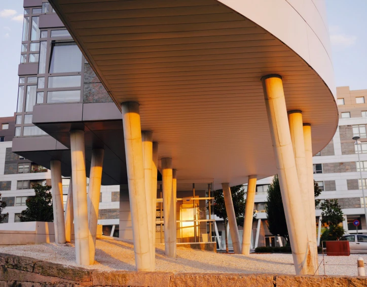 a red fire hydrant sitting in front of a tall building, a digital rendering, inspired by Zha Shibiao, unsplash, modernism, steel archways, evening sunlight, espoo, sportspalast amphitheatre