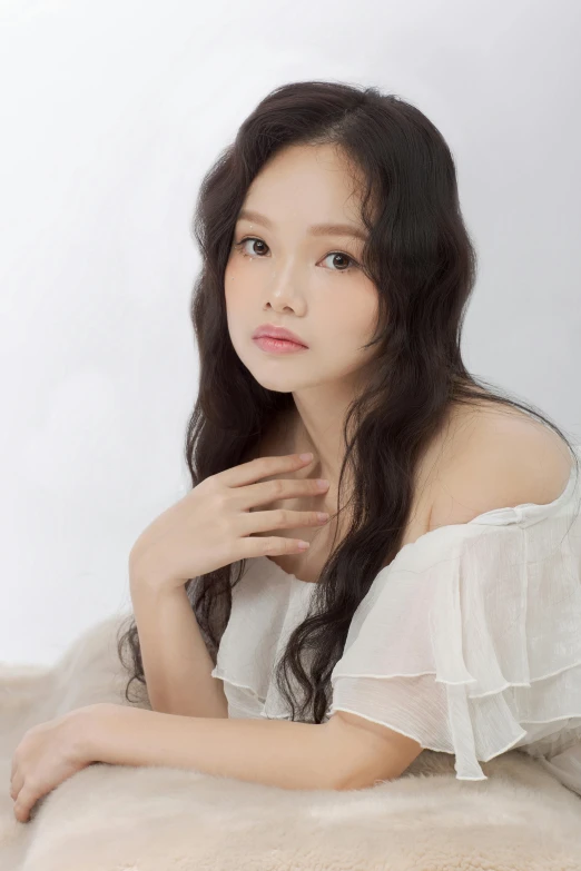 a beautiful young woman laying on top of a bed, by Ni Tian, soft round face, wide forehead, joon ahn, on a pale background