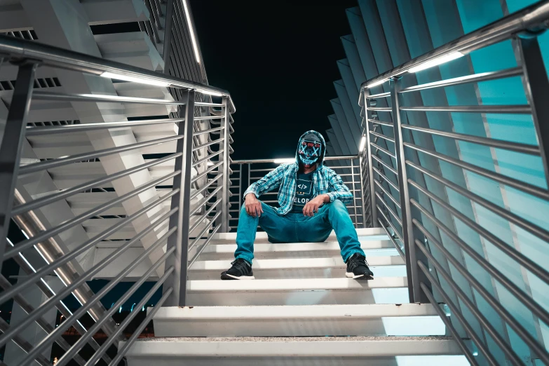 a man sitting on top of a set of stairs, inspired by Beeple, pexels contest winner, graffiti, elaborate lights. mask on face, with teal clothes, avatar image, scary pose