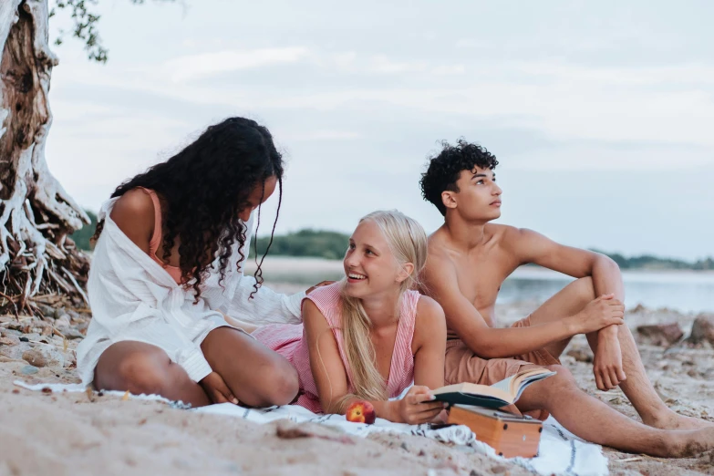 a group of people sitting on top of a sandy beach, pexels contest winner, happening, 3 young and beautiful women, people on a picnic, avatar image, sydney sweeney