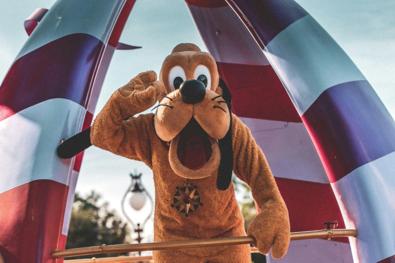 a close up of a person in a goofy costume, a cartoon, inspired by disney, pexels, on the deck of a sailing ship, pluto, fourth of july, amusement park interior design