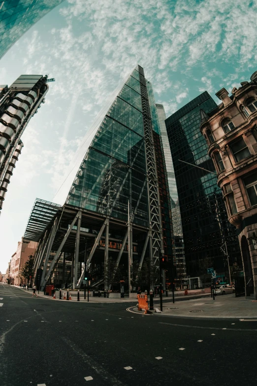 a man riding a skateboard down a street next to tall buildings, a picture, by Jay Hambidge, pexels contest winner, modernism, huge glass structure, (fish eye), in london, panoramic