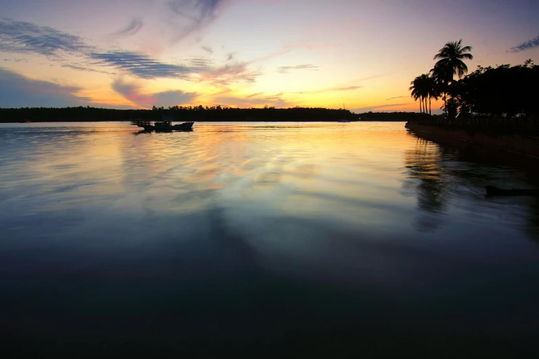 a boat floating on top of a body of water, by Peter Churcher, pexels contest winner, hurufiyya, sunset panorama, beautiful magical palm beach, soft light, lagoon