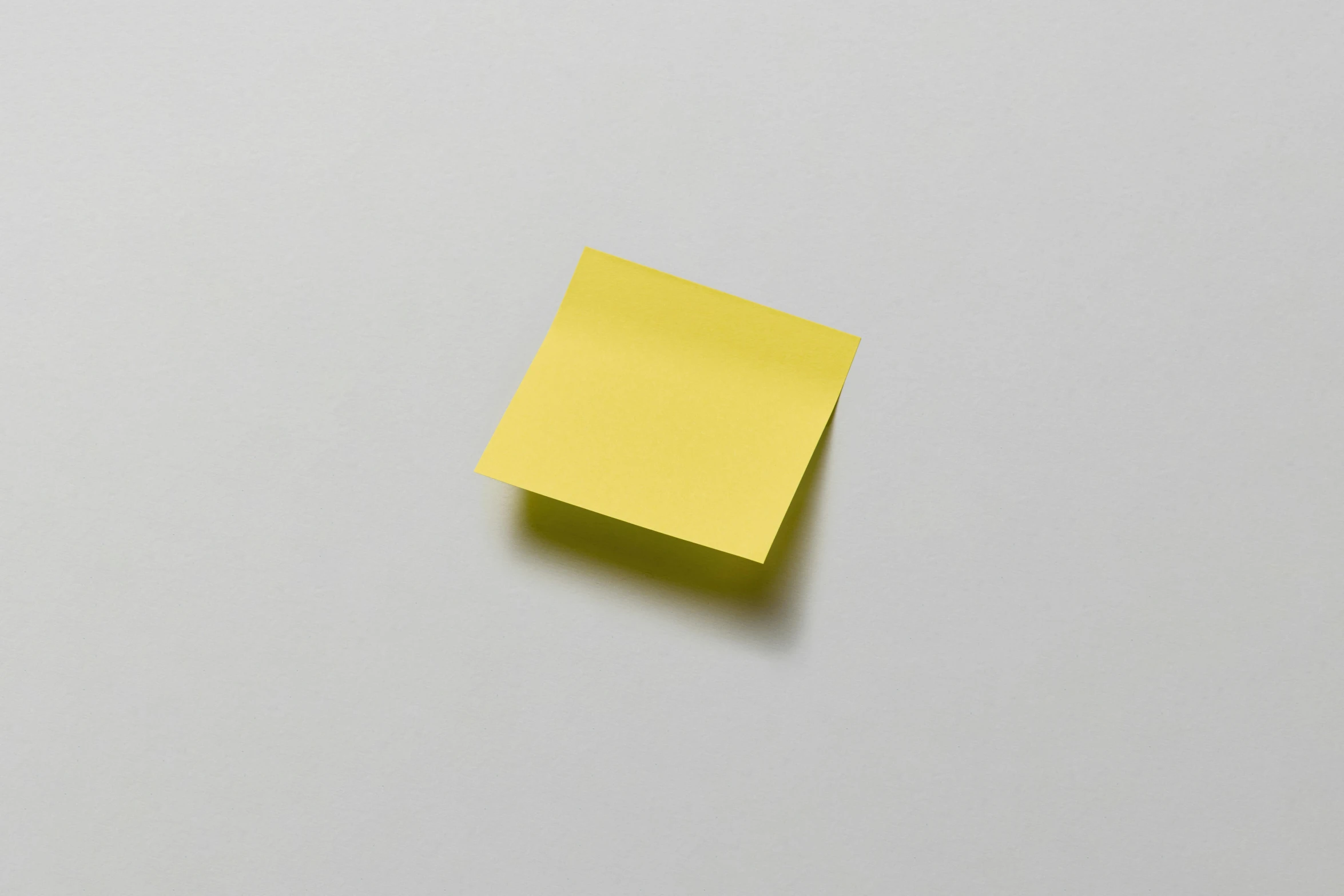 a yellow post it note sitting on top of a white surface