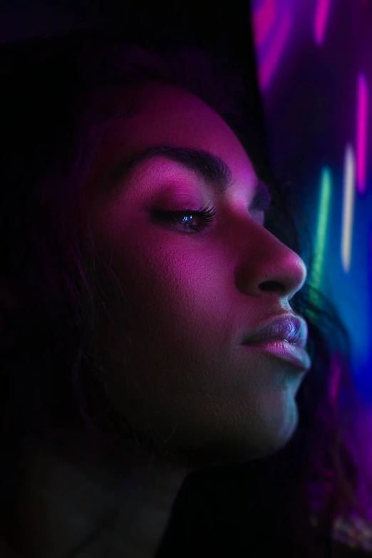 a woman standing in front of a neon light, an album cover, trending on pexels, backlit beautiful face, black young woman, discreet lensflare, iridescent aesthetic