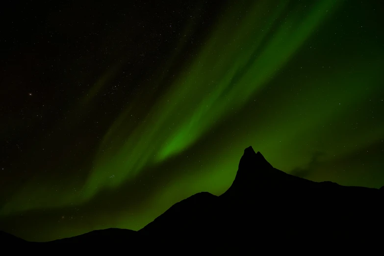 the aurora lights up the night sky over a mountain, by Þórarinn B. Þorláksson, pexels contest winner, hurufiyya, gradient green black, view from below, bright green dark orange, grey