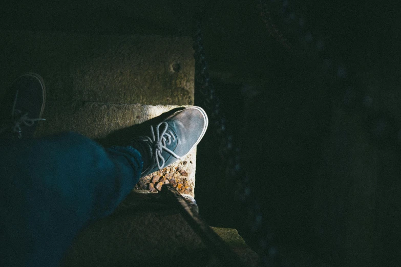 a person standing on a ledge in the dark, a picture, detailed foot pov, chillhop, grunged up, thalassophobia