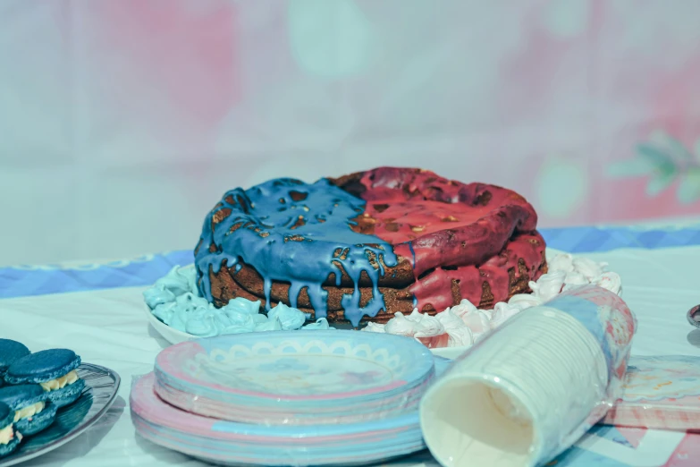 a cake sitting on top of a table covered in frosting, by Elsa Bleda, unsplash, process art, red and blue garments, vaporwave colors, made of food, made out of clay