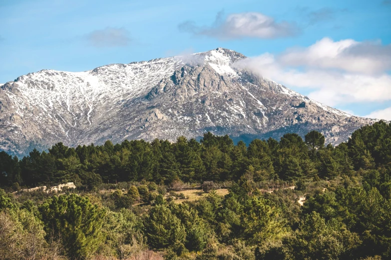 a mountain covered in snow next to a forest, by Juan Giménez, unsplash, les nabis, traditional corsican, 2000s photo, no cropping, costa blanca