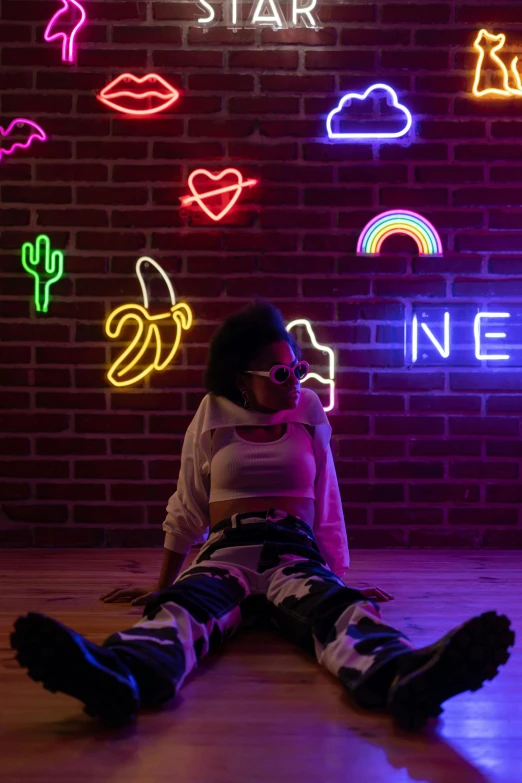 a woman sitting on the floor in front of a neon sign, trending on pexels, neon tattoo, ((neon colors)), neo soul, with a cool pose