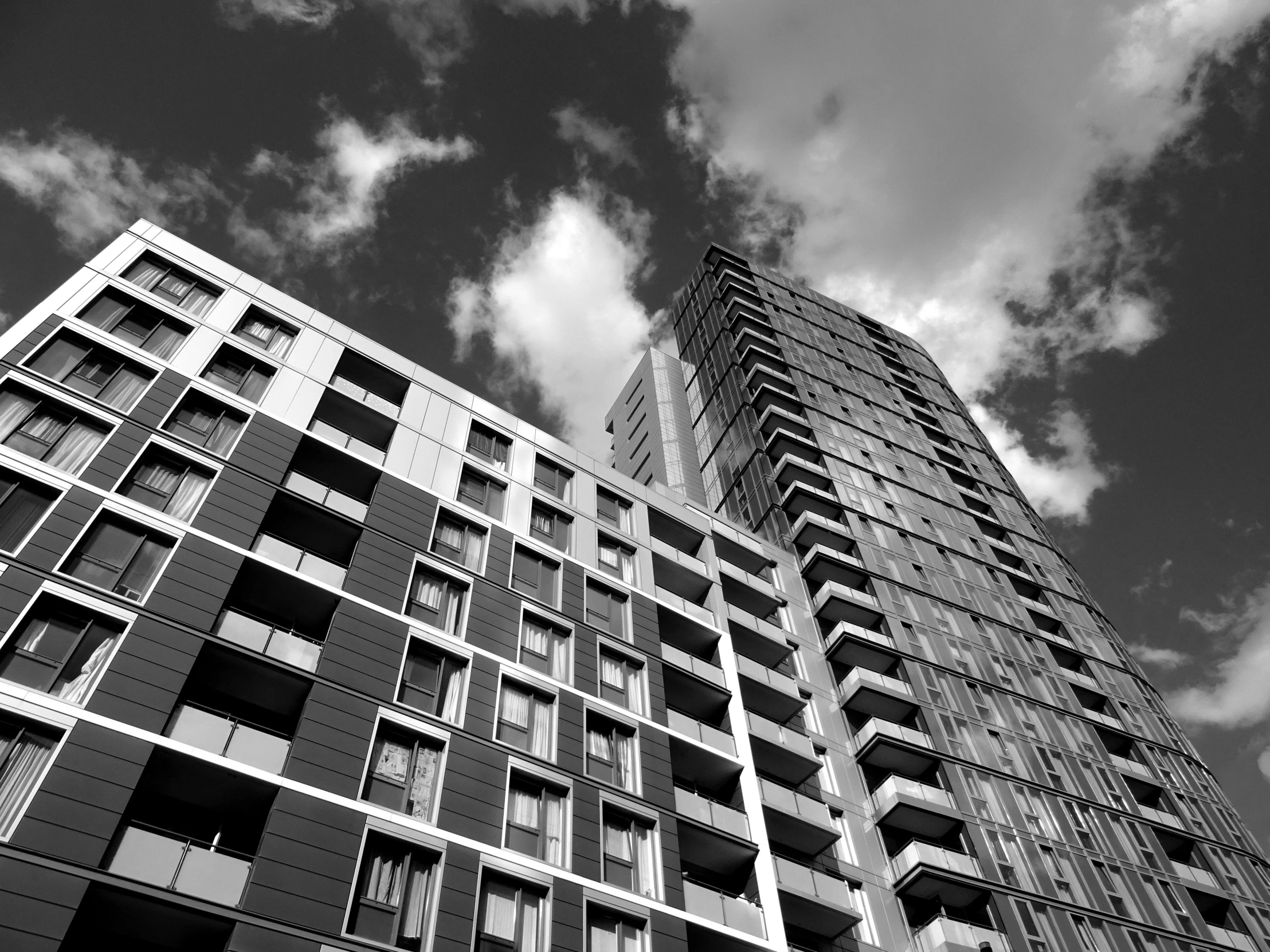 a black and white photo of a tall building, by Dave Allsop, unsplash, mass housing, regeneration, july 2 0 1 1, square