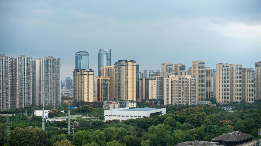 a train traveling through a city next to tall buildings, inspired by Cheng Jiasui, pexels contest winner, hyperrealism, panorama view, baotou china, city buildings on top of trees, f / 1. 9 6. 8 1 mm iso 4 0