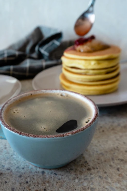 a stack of pancakes sitting on top of a counter next to a cup of coffee, bauhaus, thumbnail, iwakura, gray, soup