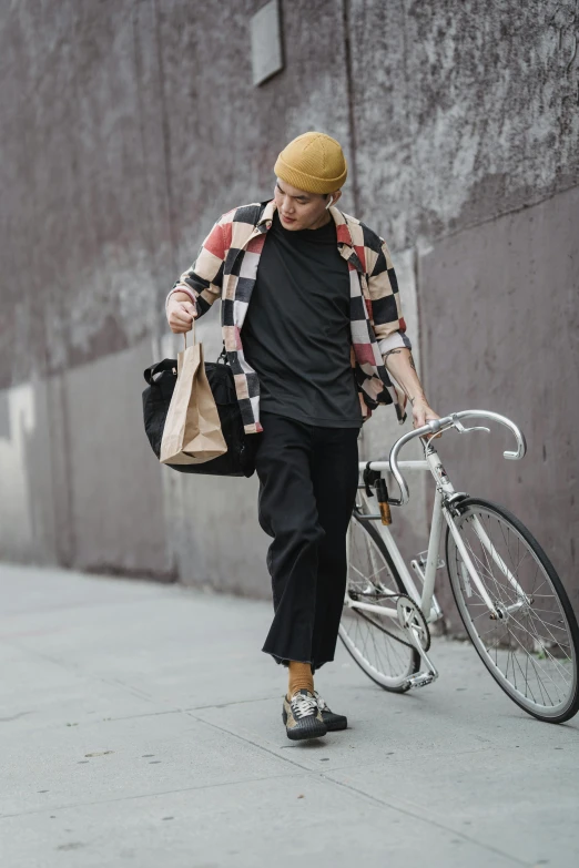 a man walking down a sidewalk with a bike, she is wearing streetwear, grid of styles, large)}], shopping groceries