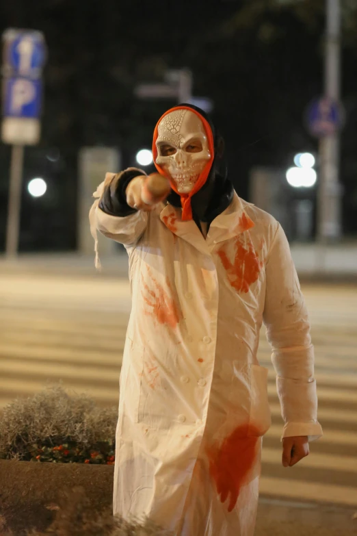 a man dressed as a zombie walking down the street, by Attila Meszlenyi, reddit, white and orange, masked, brandishing a gun, in russia