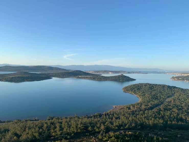a large body of water surrounded by trees, a picture, pexels contest winner, hurufiyya, vallejo, lake in the distance, looking down from above, eucalyptus
