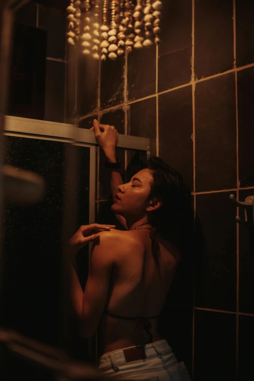 a woman standing in a bathroom next to a shower, inspired by Nan Goldin, pexels contest winner, asian women, gif, sexy movie photo, man