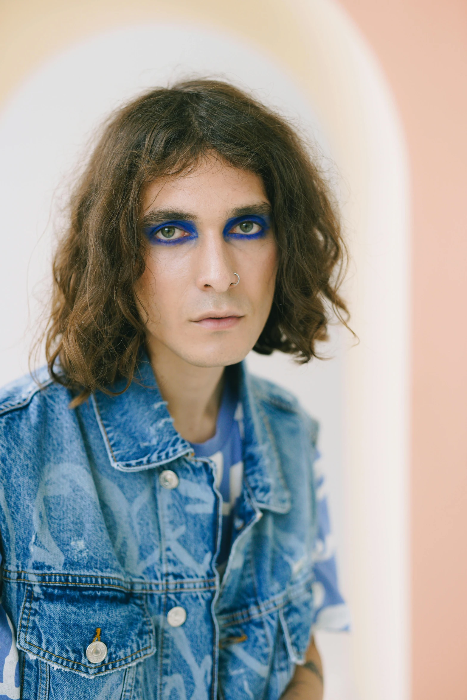 a woman with blue eyes and a denim jacket, an album cover, inspired by Davide Sasselli, trending on pexels, temples, linus sebastian, stern look, cait miers