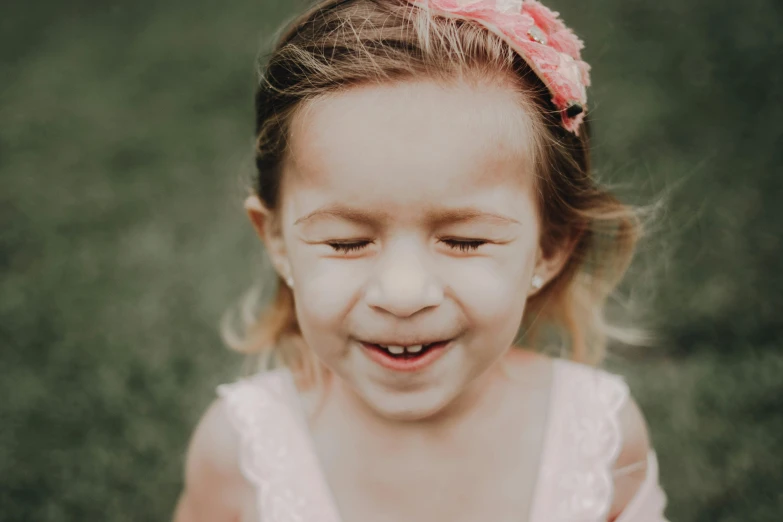 a little girl with a pink flower in her hair, pexels contest winner, large front teeth, paul barson, shy looking down, katelynn mini cute style