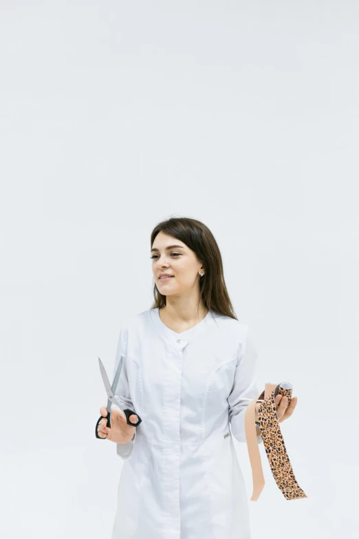 a woman in a white lab coat holding a pair of scissors, by Olivia Peguero, human-animal hybrid, high quality photo, charli xcx, reza afshar