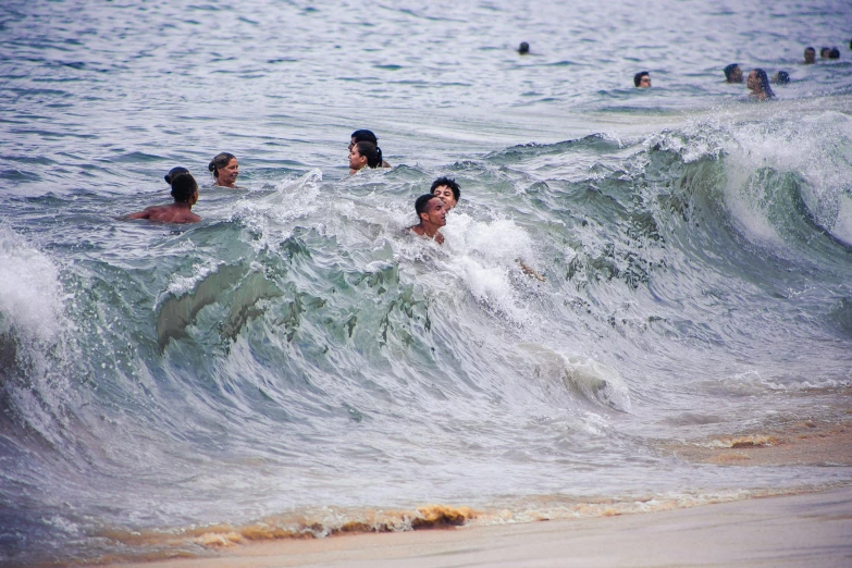 a group of people swimming in the ocean, by Carey Morris, pexels contest winner, happening, malayalis attacking, currents, relaxing at the beach, ((waves