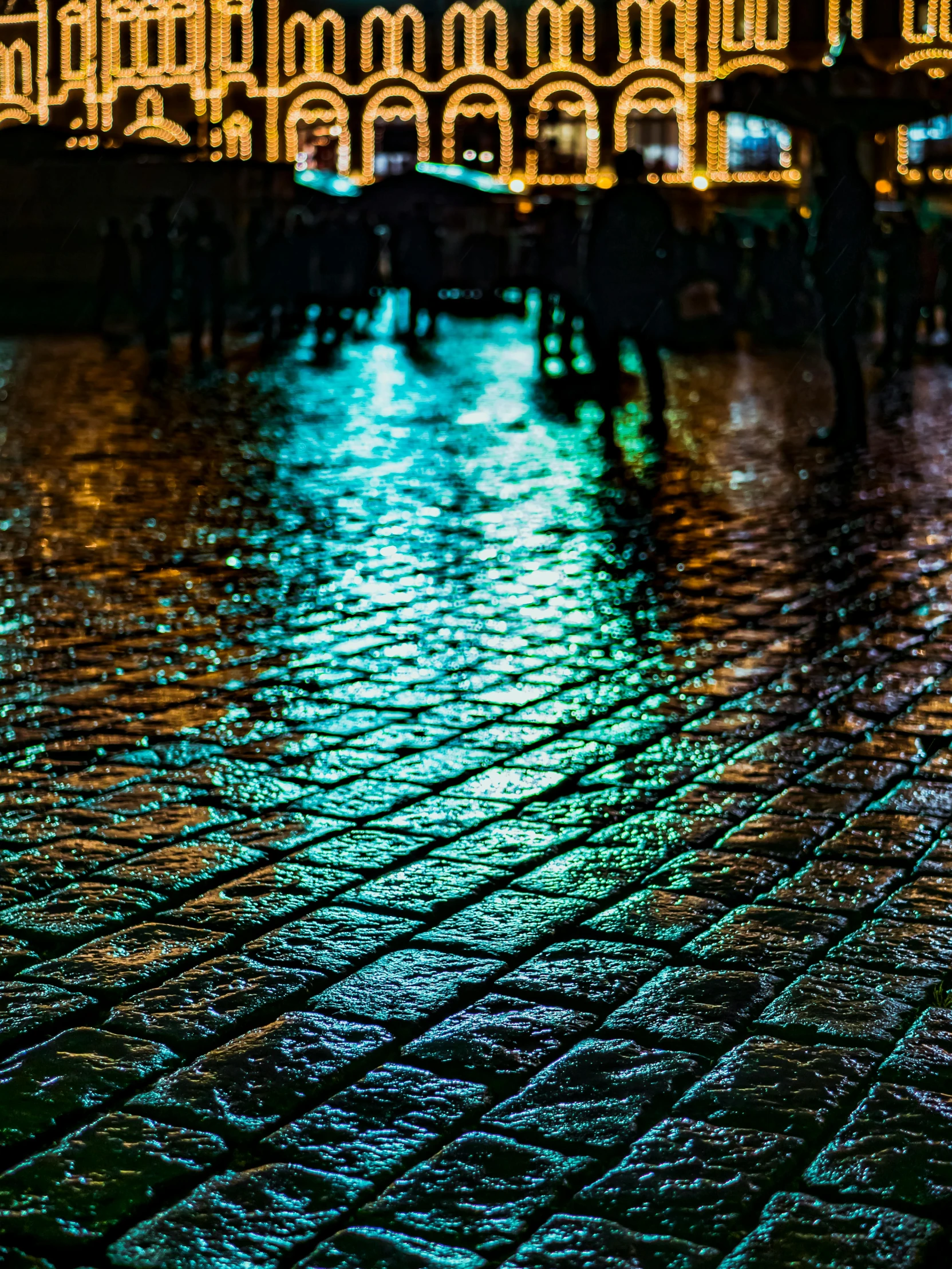 a person walking in the rain with an umbrella, blue cobblestones, colourful lighting, shot on sony a 7, in a square