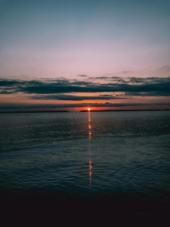 the sun is setting over a body of water, pexels contest winner, slight overcast, transparent background, multiple stories, dramatic light 8 k
