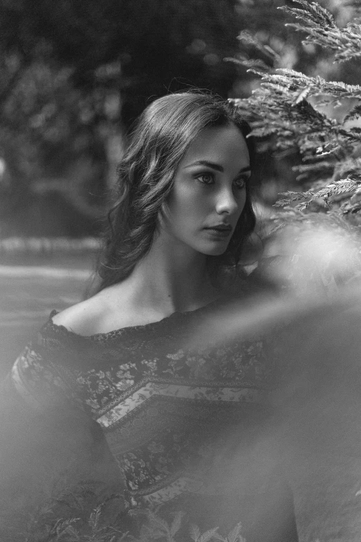 a black and white photo of a woman leaning against a tree, inspired by irakli nadar, digital art, masterpiece! portrait of arwen, alexey gurylev, 🤤 girl portrait, gal gadot portrait