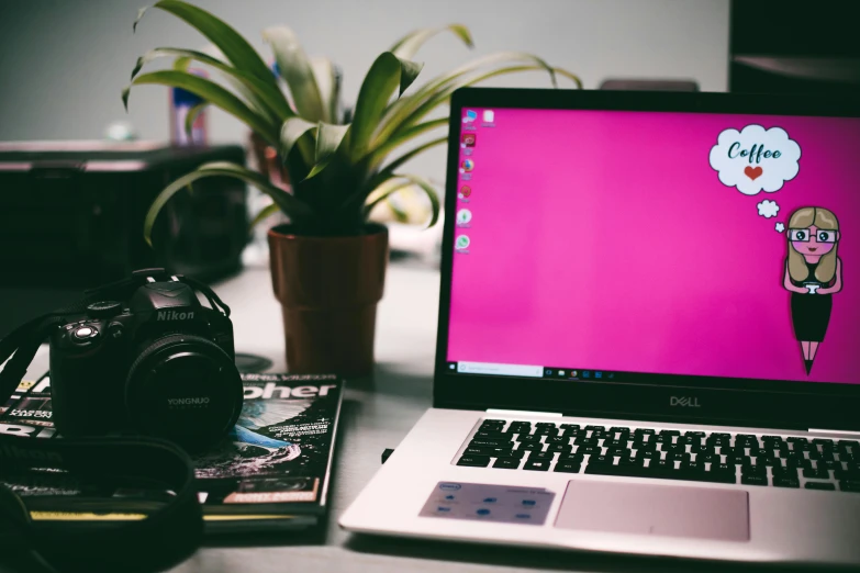 a laptop computer sitting on top of a desk next to a camera, trending on pexels, computer art, magenta colours, next to a plant, computer screens, pink headphones