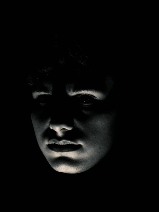 a black and white photo of a man's face, an album cover, inspired by Gottfried Helnwein, unsplash, realism, frodo, creepy child, detailed glowing head, high contrast 8k