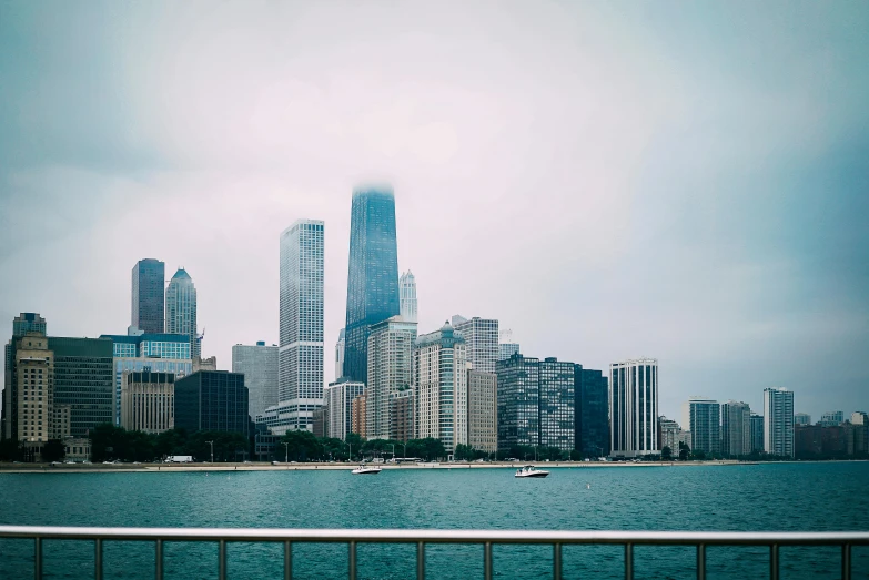 a large body of water with a city in the background, inspired by Thomas Struth, pexels contest winner, modern chicago streets, overexposed photograph, an eerie, judy chicago