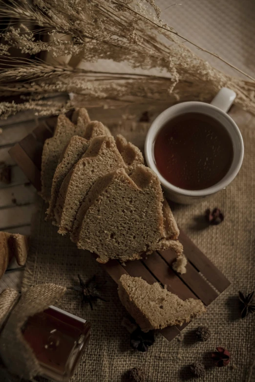 a plate topped with slices of bread next to a cup of tea, a still life, by Adam Marczyński, pexels contest winner, renaissance, hot cocoa drink, mendelbrot fractal, thumbnail, sichuan