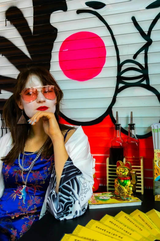 a woman with face paint sitting in front of a wall, inspired by Shinoda Toko, quirky shops, hippie chic, festivals, red and white neon