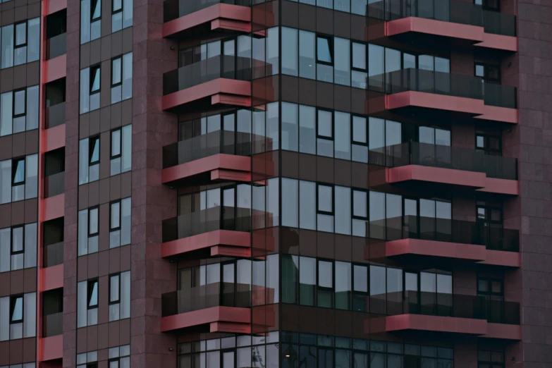 a very tall building with lots of windows, inspired by Ricardo Bofill, unsplash, brutalism, payne's grey and venetian red, telephoto shot, pink, neo norilsk