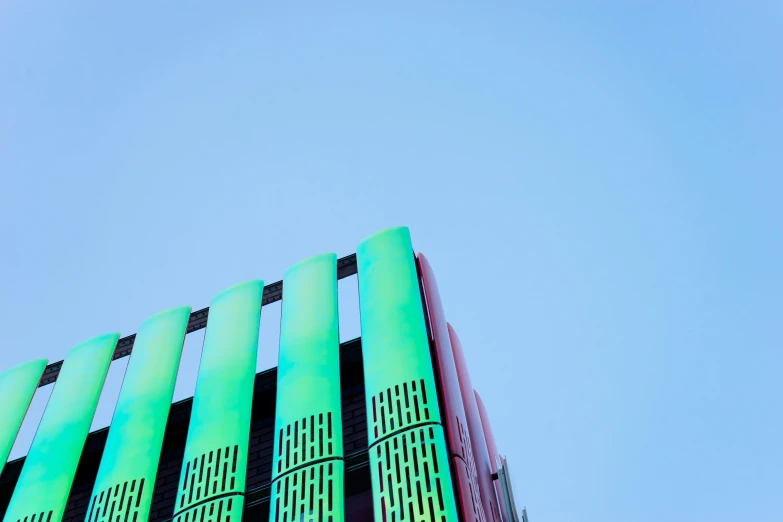 a tall building with a blue sky in the background, an album cover, unsplash, berlin secession, turquoise pink and green, glowing tubes, green colours, colourful books