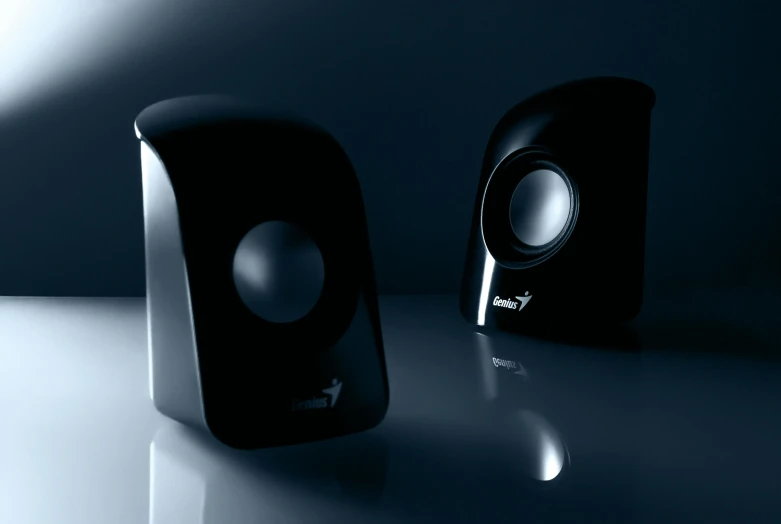 a pair of speakers sitting on top of a table, desktop wallpaper, slightly smiling, black plastic, uplit