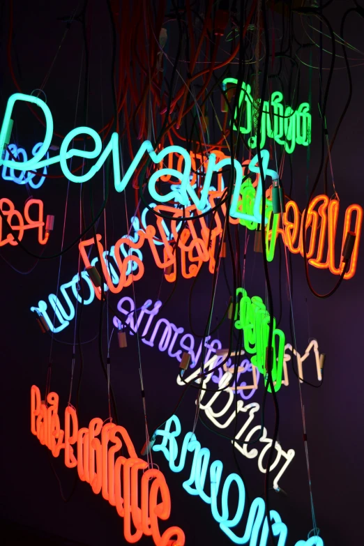 a bunch of neon signs that are on a wall, inspired by Cerith Wyn Evans, devoted, dynamic closeup, divayth fyr, hanging