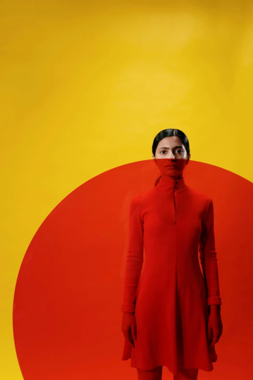 a woman standing in front of a red circle, inspired by Marina Abramović, color field, wearing turtleneck, wearing red and yellow hero suit, mariko mori, davide sorrenti