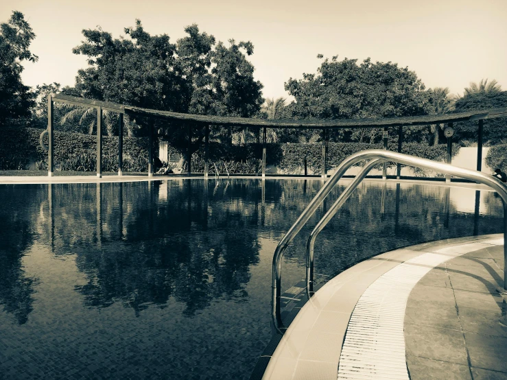 a black and white photo of a swimming pool, inspired by Max Dupain, unsplash, bauhaus, sepia toned, “ iron bark, 1940s photo, tourist photo