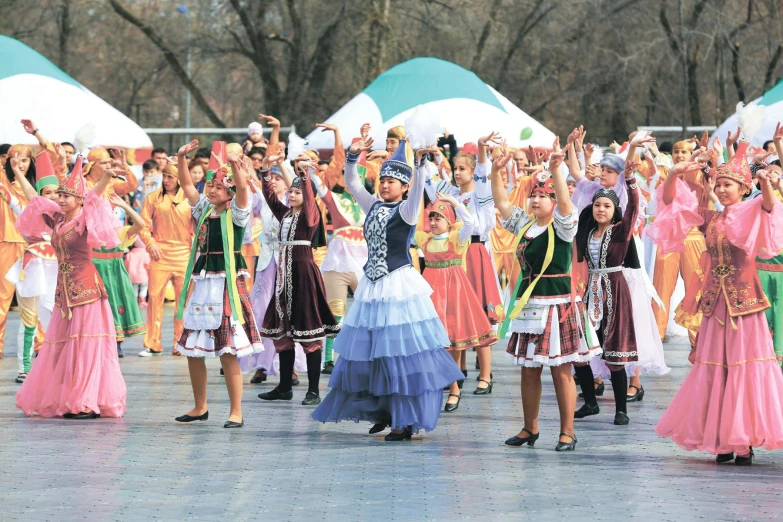 a group of people that are standing in the street, a photo, hurufiyya, dancing gracefully, wide skirts, winter season, performing on stage